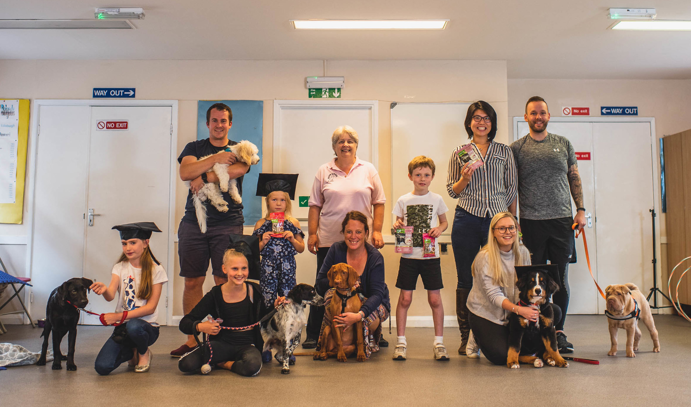 Puppy School graduation owners and puppies with trainer